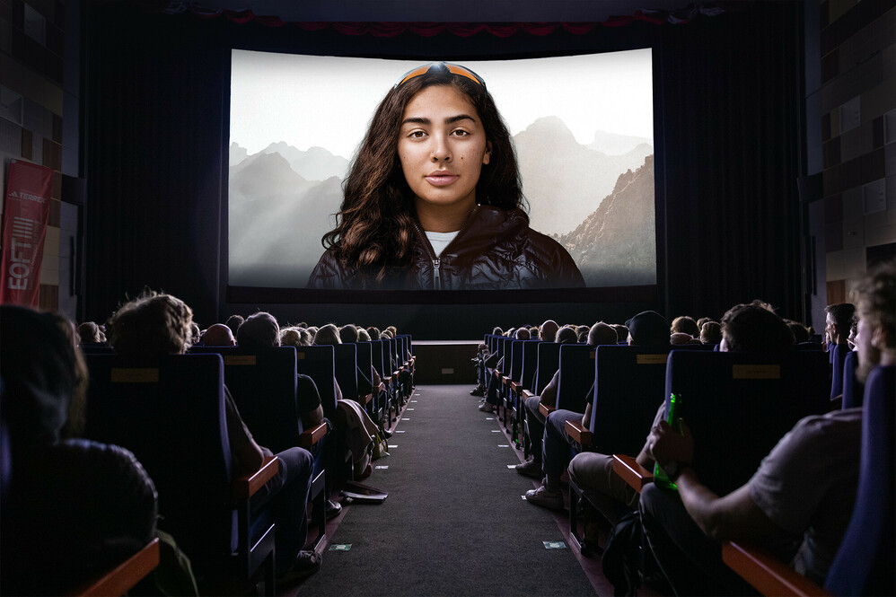 A movie theater with an audience and a big screen